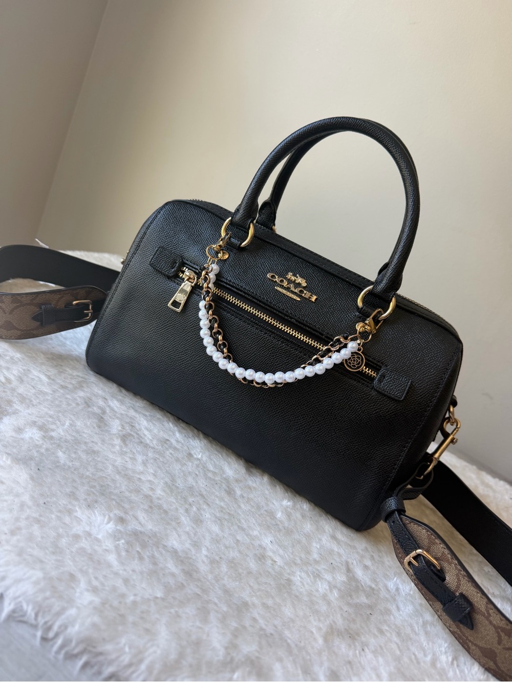 Caoch Rowan black leather bag with guitar strap and chain charm